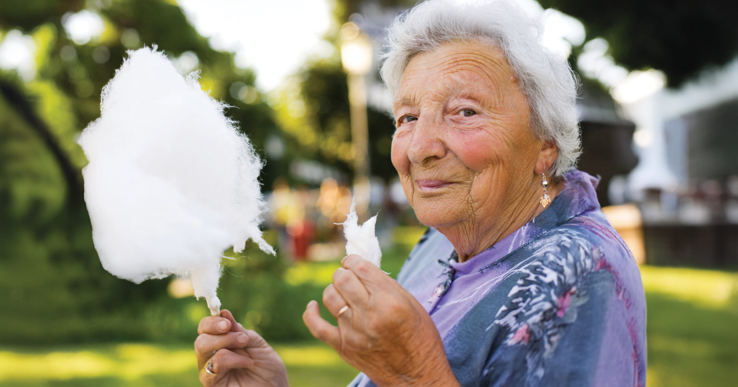 Senior woman eating cotton candy